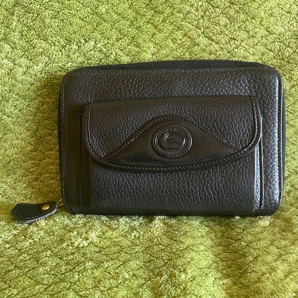 Dooney and Bourke zip along wallet in solid black. - Picture 1 of 12